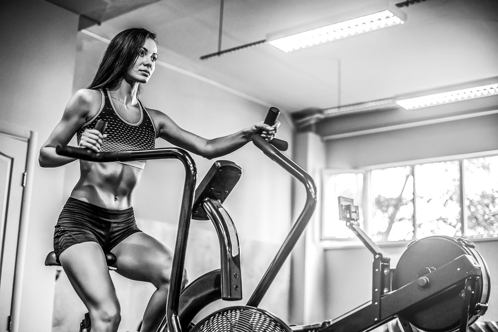 woman doing Crossfit on Assault Bike